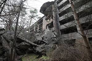 Abandoned building overgrown with trees, a key spot on the lost places map for urban exploration enthusiasts.