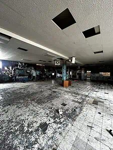 Graffiti-covered abandoned room with debris on the floor, ideal for urban exploration and featured on a lost place map.