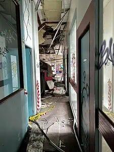 Decaying hallway in an abandoned building, perfect for urban exploration enthusiasts and lost place map seekers.