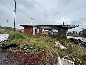Abandoned brick building on overgrown land, perfect for urban exploration. Check lost place map for more locations.
