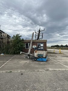Abandoned building with graffiti and debris under cloudy skies, ideal for urbex adventures on a lost places map.